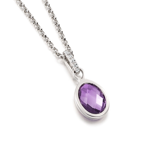 A bezel pendant necklace with a faceted purple amethyst gemstone in an oval shape with a delicate diamond bail.
