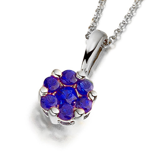 A floral-inspired cluster pendant featuring vivid blue sapphires.
