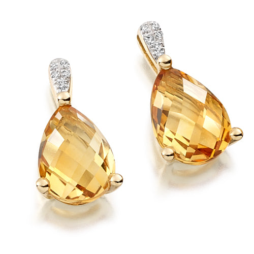 Expertly crafted, these Citrine & Diamond Drop Earrings feature faceted citrine stones in a pear shape, held by a sparkling diamond bail.