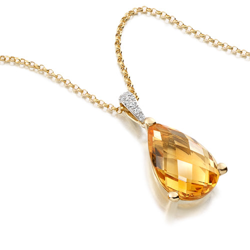 A gold pear-shaped citrine pendant with a diamond bail on a chain.