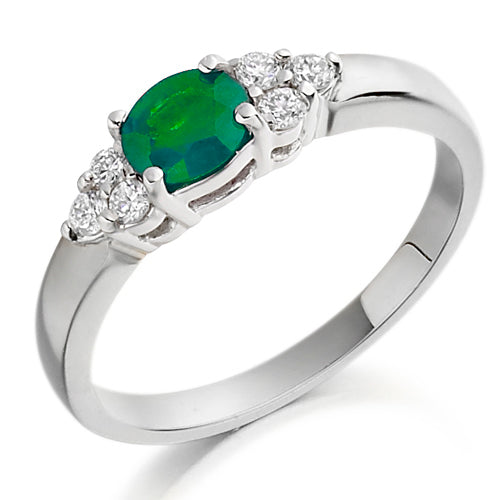 This Emerald & Diamond Trefoil Ring features a trio of vivid emeralds arranged in a graceful trefoil pattern, accented with shimmering diamonds.