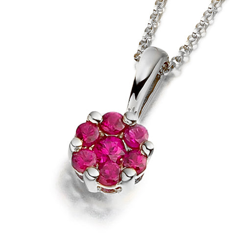 A floral cluster pendant featuring vivid red rubies.