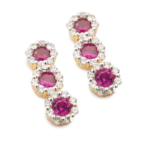 A pair of ruby halo drop earrings with sparkling diamonds set in a yellow gold design.
