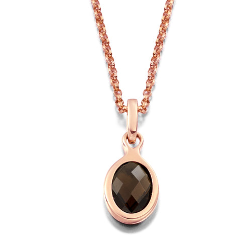 This smoky quartz Bezel Pendant features a faceted smoky quartz in an oval shape, delicately held by a diamond bail in a rubover setting.