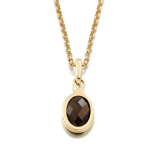A smoky quartz bezel pendant set on a gold chain, with the pendant displaying an oval shape and a faceted design.