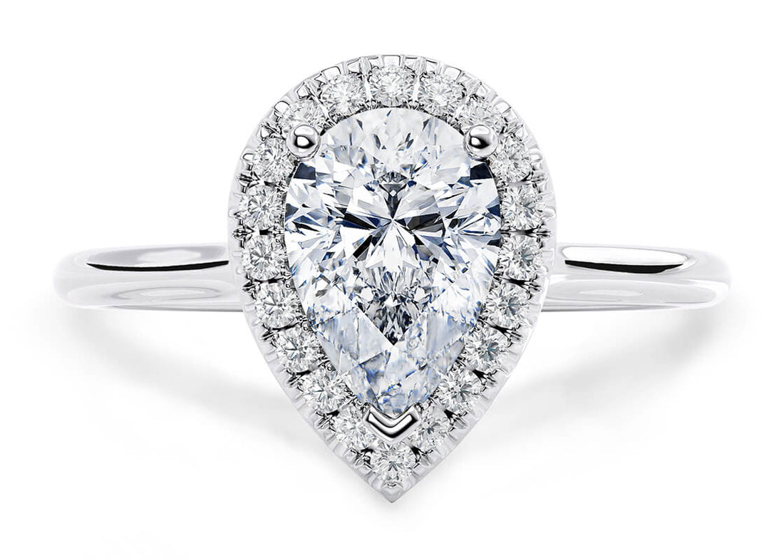 A beautiful GIA certified pear cut halo diamond engagement ring, with a 0.90ct centre diamond of E colour and VS1 clarity. Surrounding halo diamonds weigh approximately 0.15ct.  Diamonds set in a 18K White Gold mount.