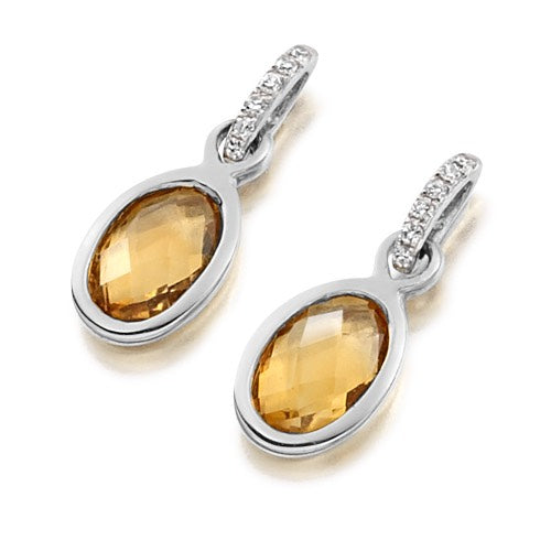 A pair of bezel set citrine and diamond drop earrings in white gold.