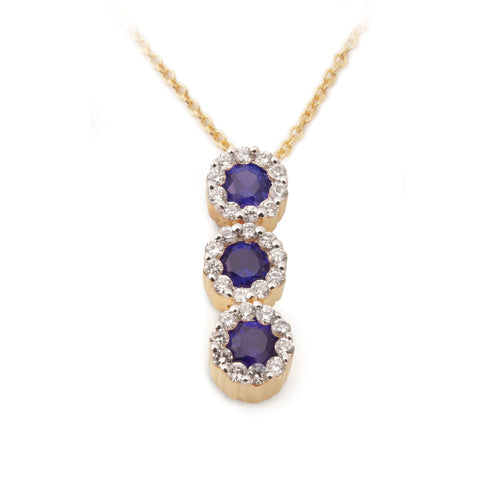 A Blue Sapphire Diamond Halo Journey Pendant with a vertical line of round blue sapphires encircled by diamond halos.