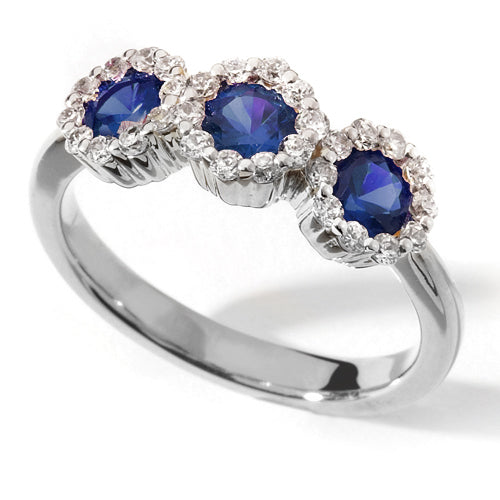 A Blue Sapphire Trilogy Ring with three blue sapphires arranged in a line with halo settings.