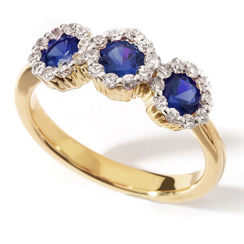 A Blue Sapphire Trilogy Ring with three blue sapphires arranged in a line with halo settings.