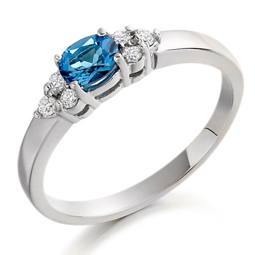 This Blue Topaz &amp; Diamond Trefoil Ring showcases a beautiful London blue topaz that adds a touch of regal elegance to any outfit.
