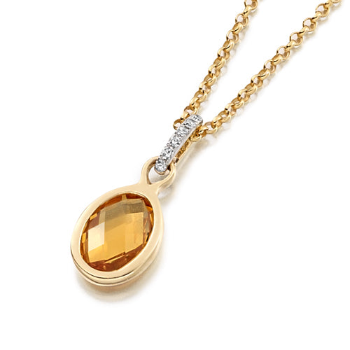 A gold bezel pendant necklace with a golden-yellow citrine gemstone and small diamond bail.