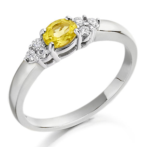 Designed with a warm, radiant citrine at its centre and flanked by two shimmering diamonds, this trefoil setting evokes grace and sophistication.