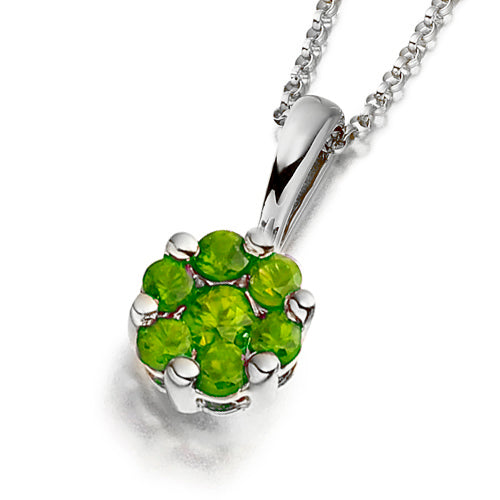 A floral-inspired cluster pendant featuring vivid green emeralds.