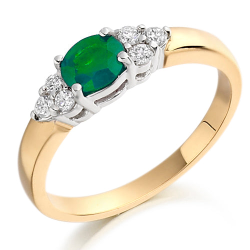 This Emerald &amp; Diamond Trefoil Ring features a trio of vivid emeralds arranged in a graceful trefoil pattern, accented with shimmering diamonds.