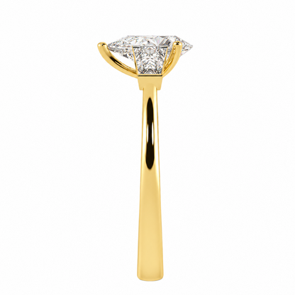 Pear &amp; Baguette Three Stone Ring in yellow gold, side view