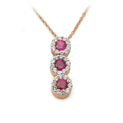 A pendant featuring a graduated journey of brilliant red rubies, each encircled by delicate halos of sparkling diamonds, suspended from a chain.