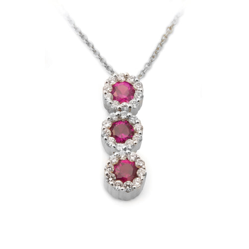 A pendant featuring a graduated journey of brilliant red rubies, each encircled by delicate halos of sparkling diamonds.