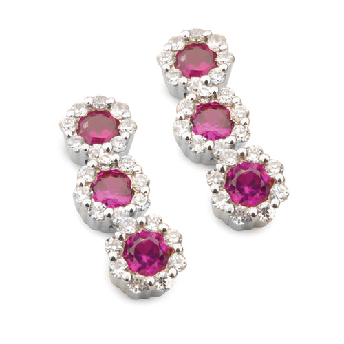 A pair of ruby halo drop earrings with sparkling diamonds set in a white gold or platinum design.