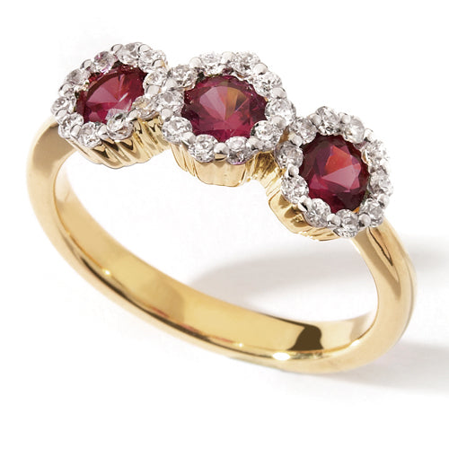 A Ruby Trilogy Ring with three red rubies set in a yellow gold band with halo diamonds around each ruby.