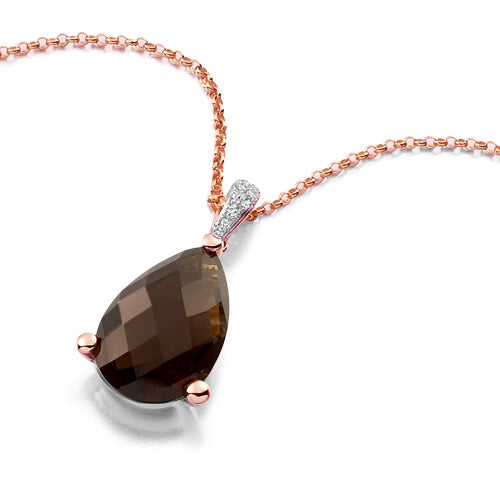 A smoky quartz pear pendant with a gold chain, featuring a faceted pear-shaped smoky quartz stone in a delicate three claw setting with a sparkly diamond bail.