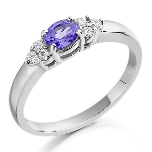Set in a charming trefoil design, three brilliant stones one central tanzanite flanked by sparkling diamonds create a graceful balance of colour and light.