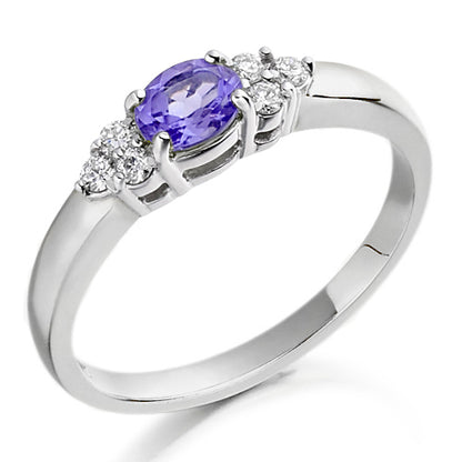 Set in a charming trefoil design, three brilliant stones one central tanzanite flanked by sparkling diamonds create a graceful balance of colour and light.