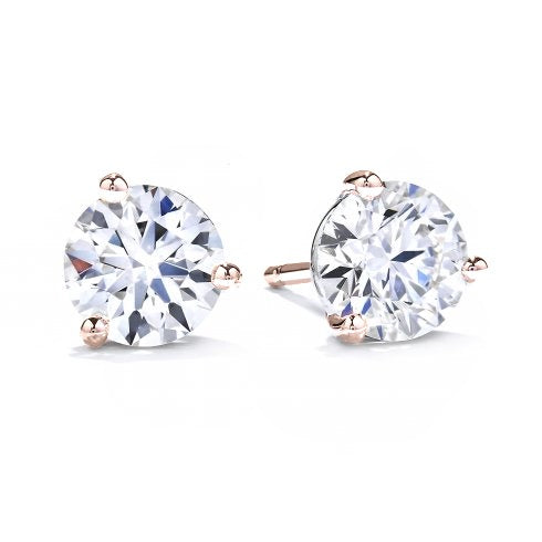 A pair of three claw solitaire earrings with round diamonds set in rose gold.