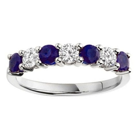 A seven stone ring with alternating blue sapphires and diamonds.